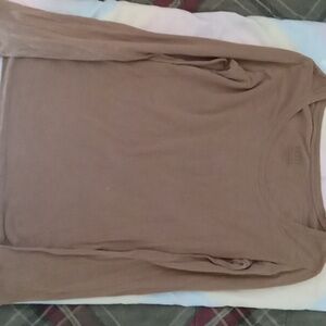 A light brown long sleeve women's top playing design long sleeve